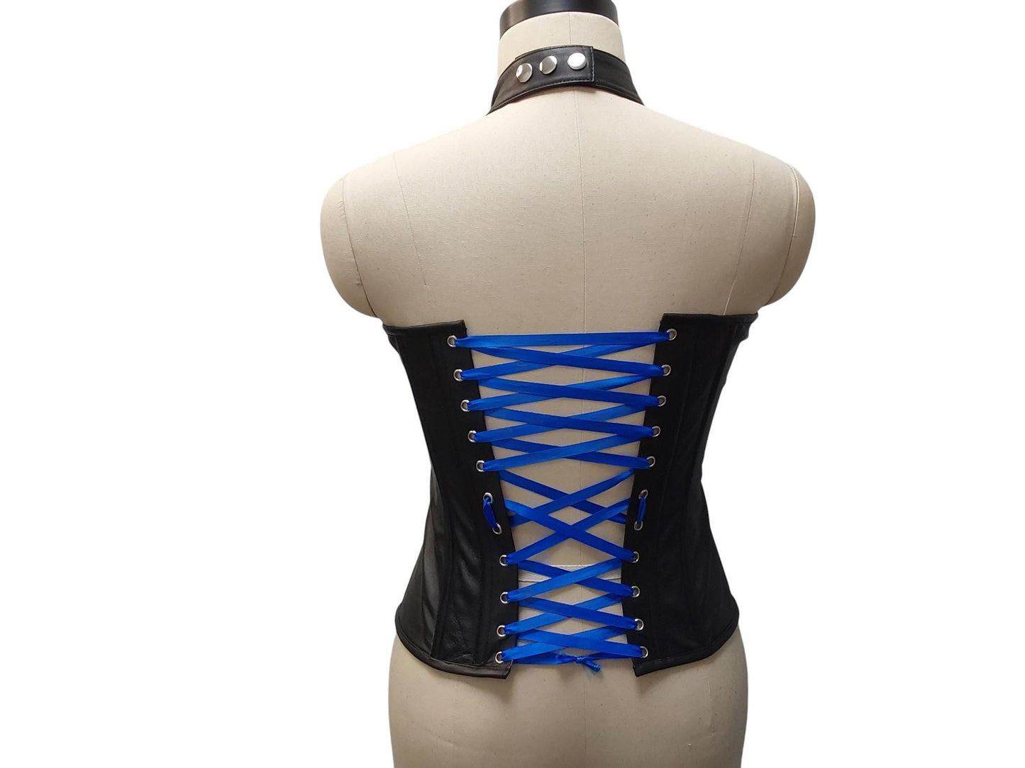 Andarta Hand-made black leather corset, bold buckle front, adjustable neck collar & lace-up back. Inspired by the goddess Andarta—power meets allure