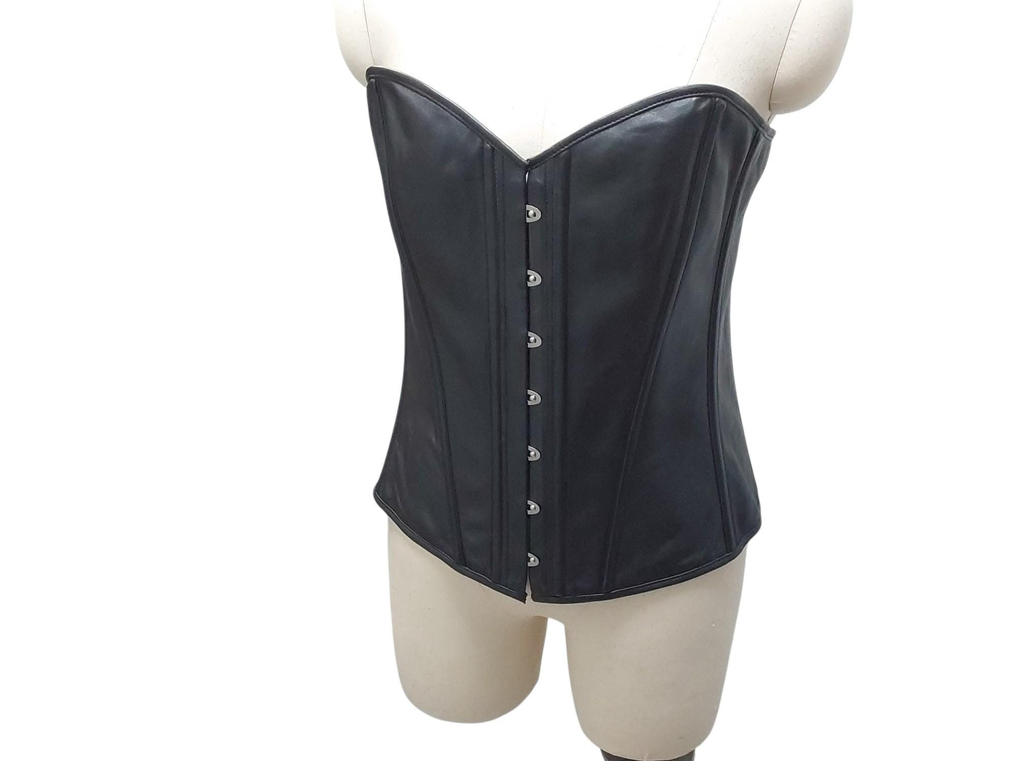 Bia—hand-crafted overbust leather corset with steel boning, full lining, and front busk. Power, structure, comfort. Black or custom colours.