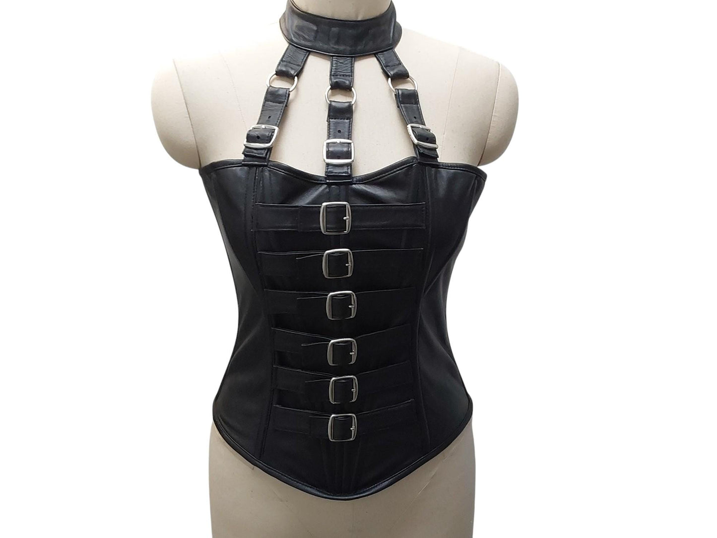 Andarta Hand-made black leather corset, bold buckle front, adjustable neck collar & lace-up back. Inspired by the goddess Andarta—power meets allure